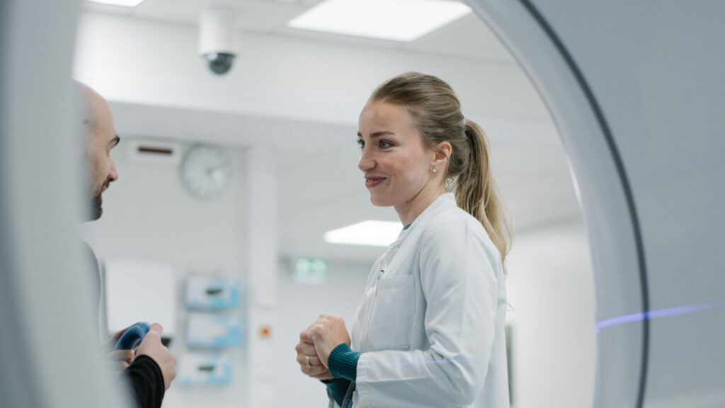Oncologist talking to a patient in a clinical setting